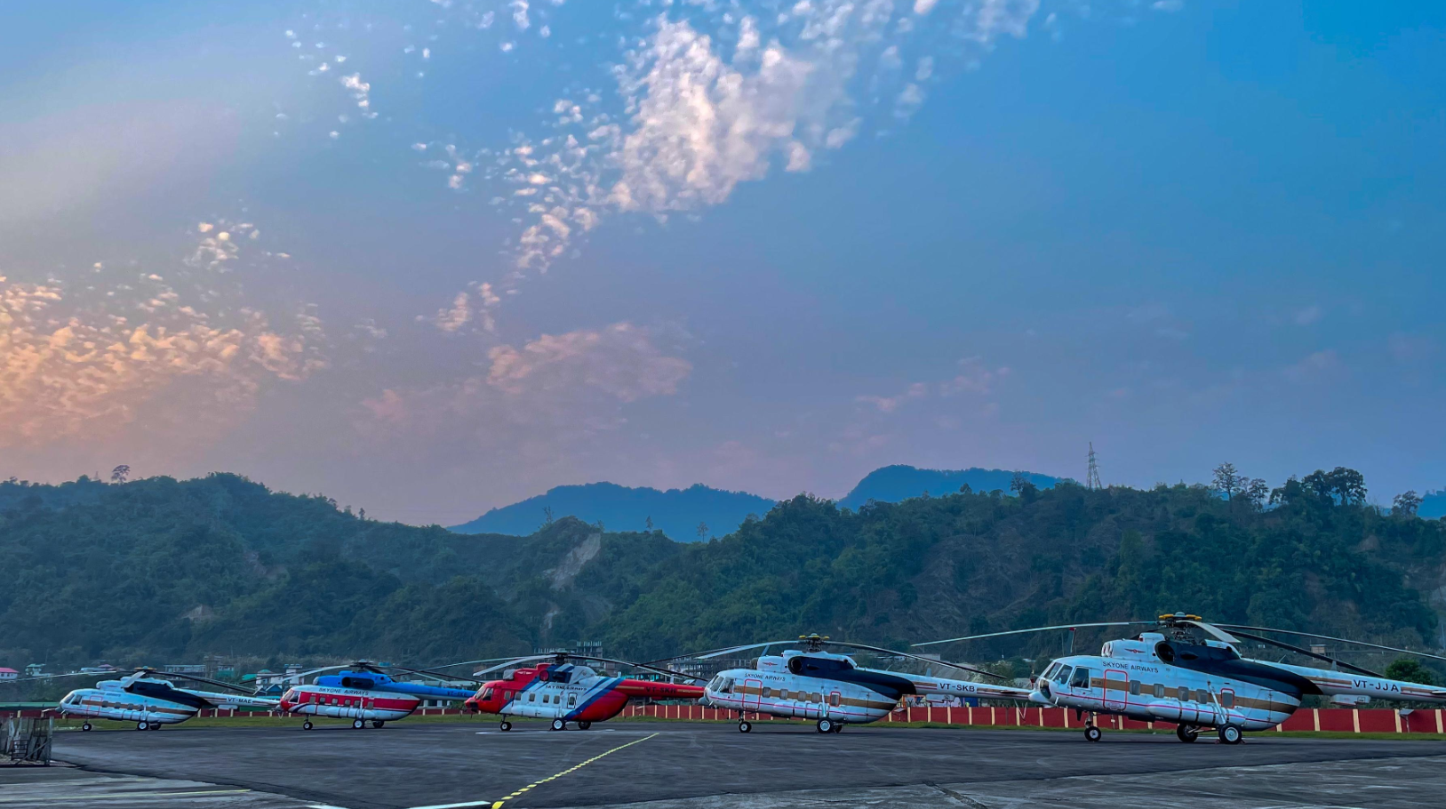 Sky One Airways Mi-172 helicopter fleet lined up on a Himalayan apron at dawn